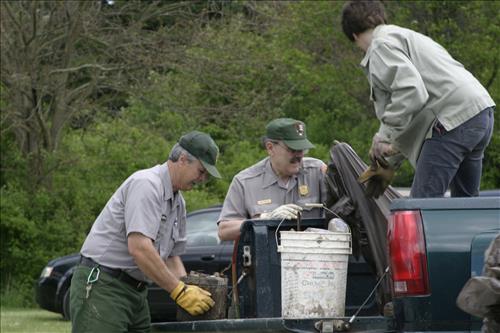 RiverDay trash clean up staff and volunteers at dumpster
