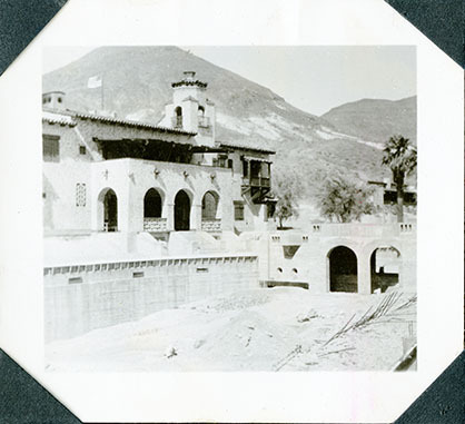 This is an historic black and white photograph from the Scotty's Castle Historic Photograph Collection, Death Valley National Park of Scotty's Castle Main House and Swimming, looking northeast. Circa 1931.