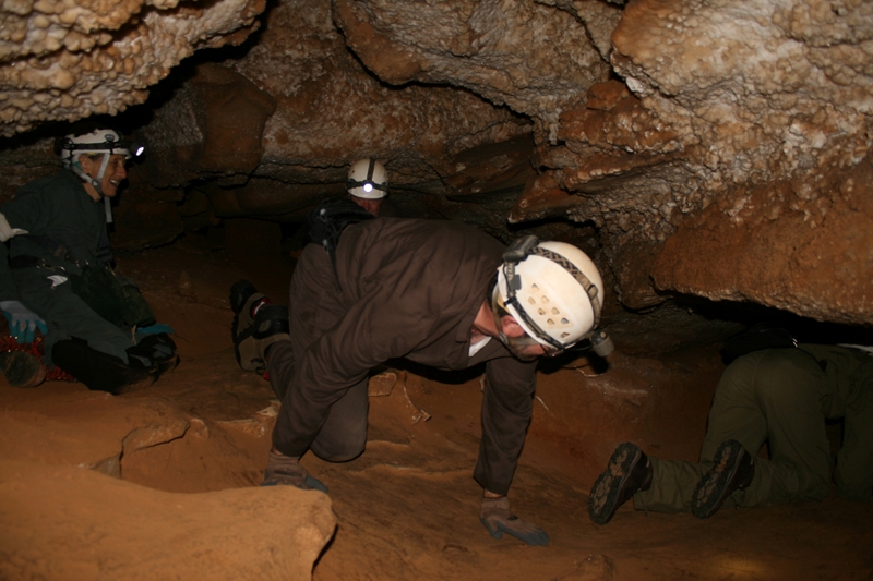 image of visitors crawling on a Wild Cave tour inside Mammoth Cave