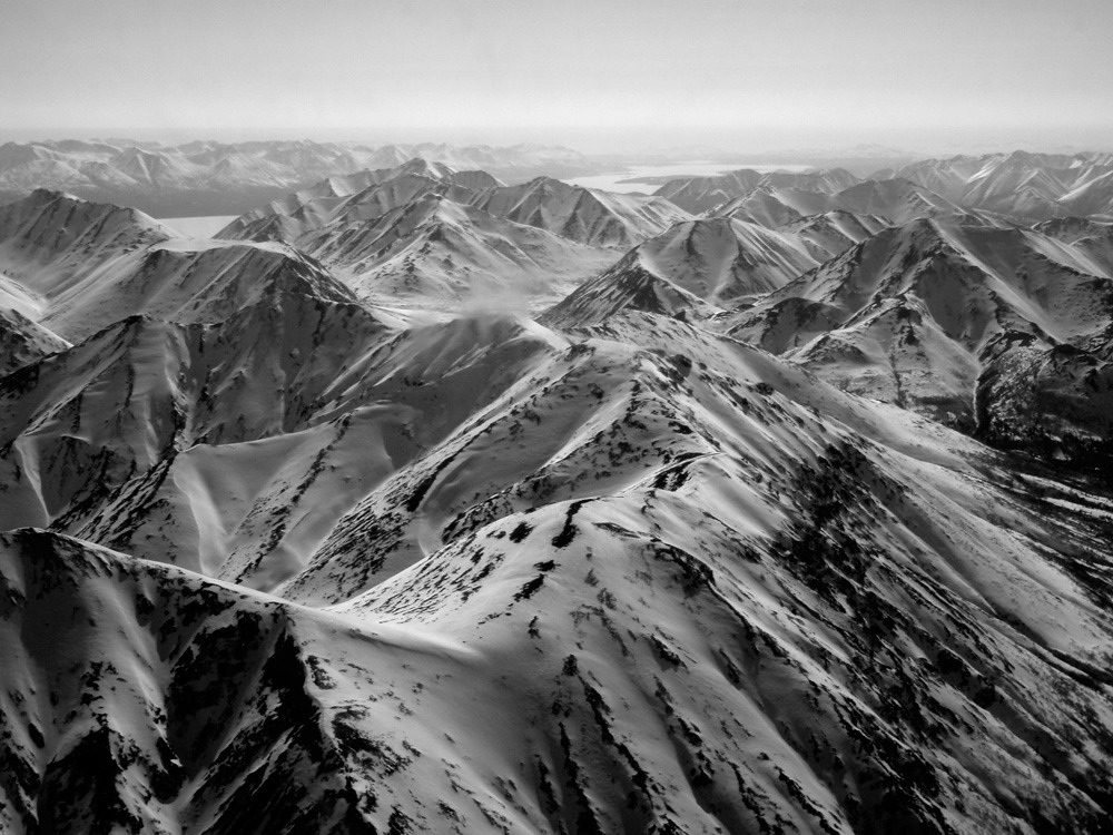 black and white image of snow-covered mountains