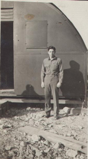 Man in front of a quonset hut