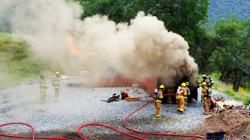 Structure fire burn box training exercise.