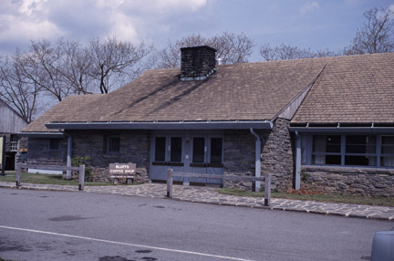 The stone construction and sloping roof of the coffee shop mimic the earlier rustic style.