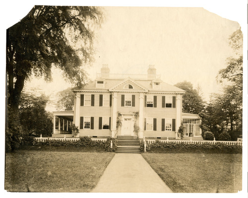 Facade of Georgian mansion, black and white photo.