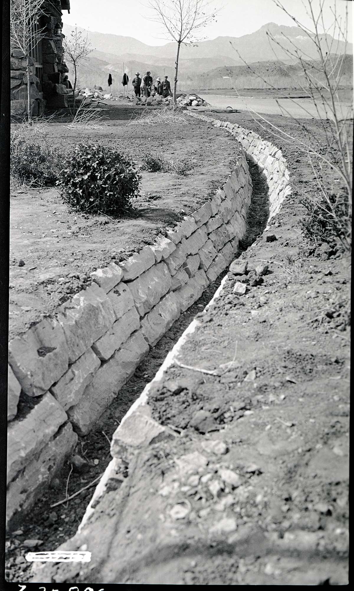 Construction of irrigation ditches in front of cafeteria, Camp Center, South Entrance.