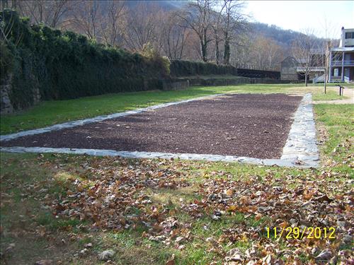 Photo views dated November 29, 2012, showing the site of the Large Arsenal foundation wall footprint, established as an interpretive exhibit, Arsenal Square, Lower town, Harpers Ferry NHP/NPS.