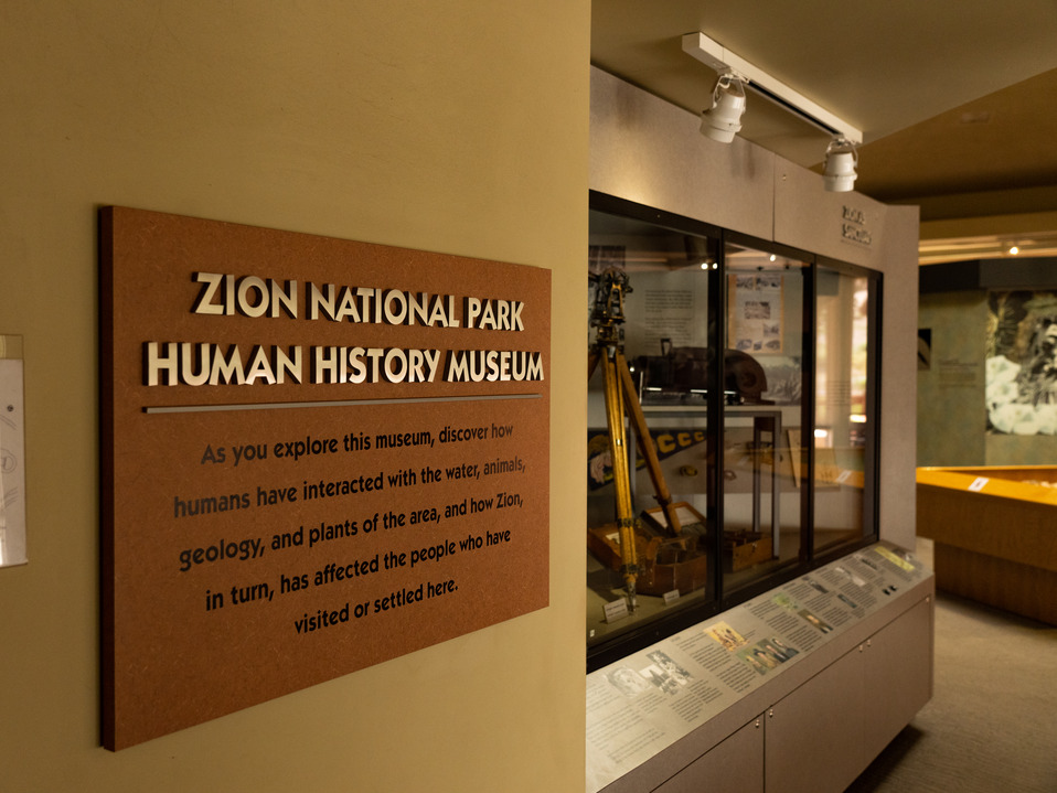 A small square sign reading "Zion National Park Human History Museum"