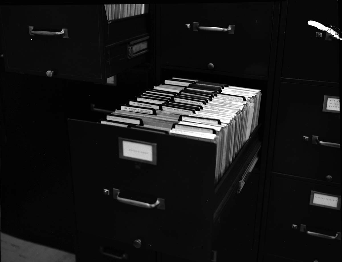 File cabinets improved by use of v-shaped block to hold file divider in place. Block suggested by Z. Brinkenhoff and made by J. Blackburn - for possible incentive award.