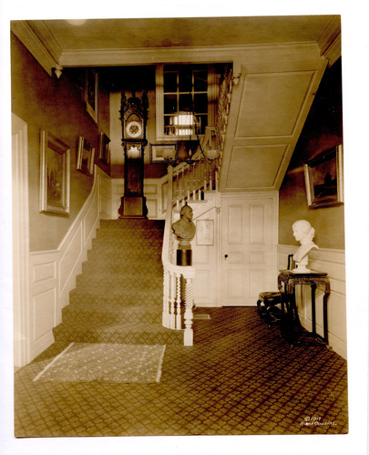 Front entry with large staircase, featuring arched window to the back of house.