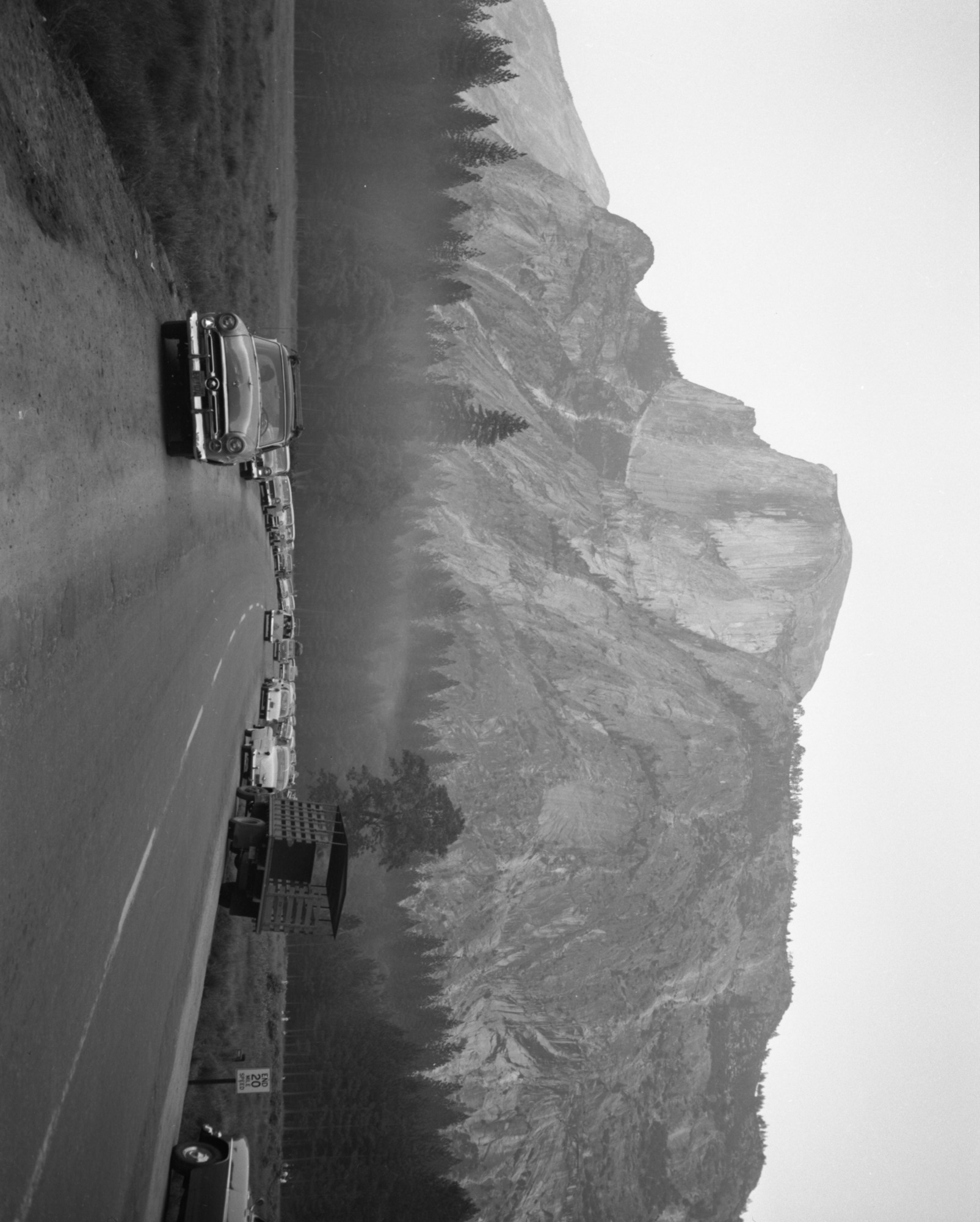 Cars parked along the road in Stoneman (Camp Curry) Meadow waiting for the "Firefall," Yosemite Valley. For official negative file of Yosemite.