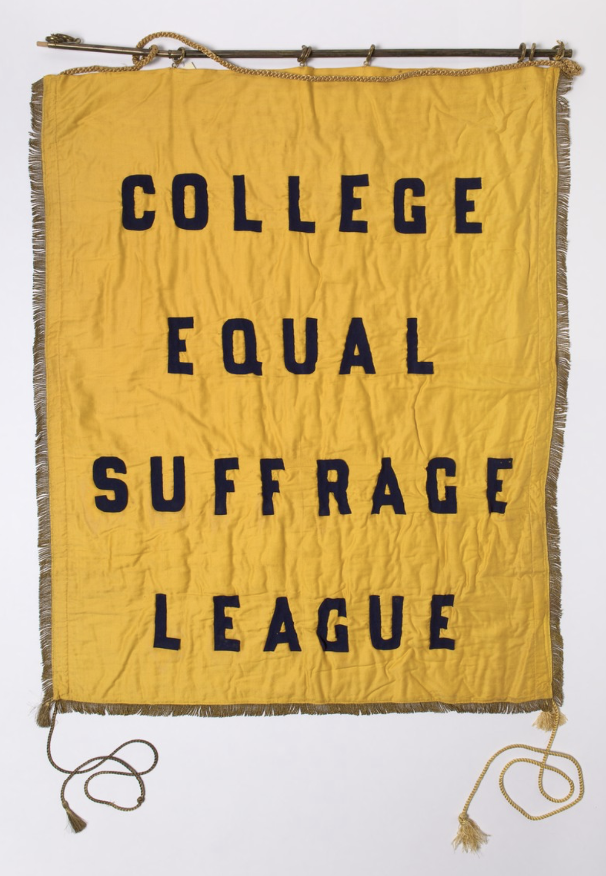 Gold banner with tassels and gold cord that reads "College Equal Suffrage League"