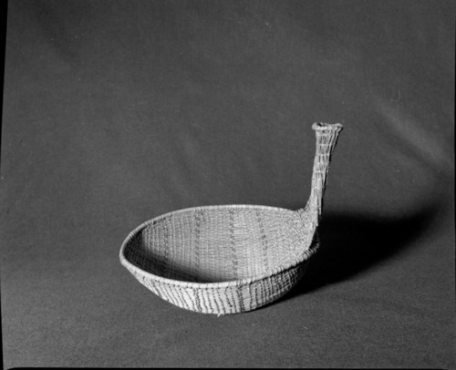 Marie Rozier Collection, Catalog No. 275. Object: Miwok seed beater. Dimensions: 11 x 11 1/2" handle 7". Materials: fern root, probably split maple shoots, scraped shoots. Technology: diagonally twined, up to right slant of turns, reversed slant of turns in last third of basket. Handle hollow at top. Collection History: Bought from Marion Steinbach, who acquired it from P.K. Gordon in August 1971. Photographed by Michael Dixon in December 1982. Catalogued by Craig Bates and Barbara Beroza. Yosemite Collections, National Park Service.