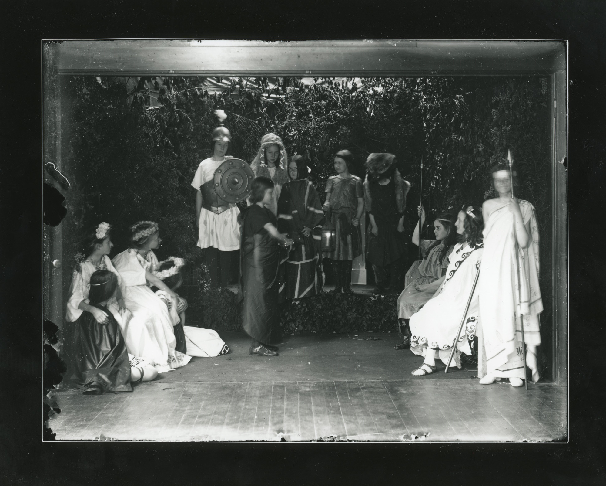 Scene of white children wearing costumes acting out a scene.