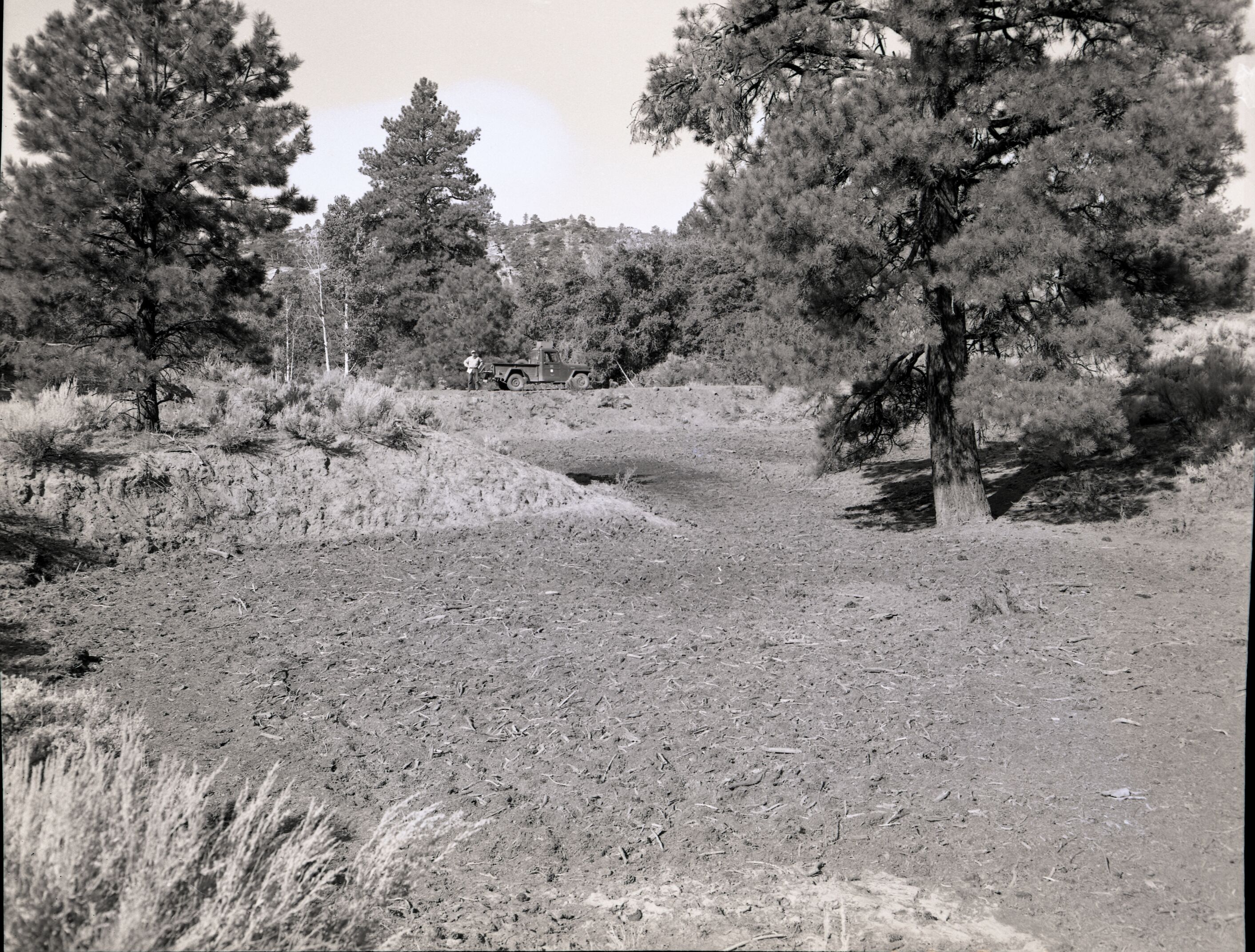 Illegally constructed water reservoir on government property in Hop Valley. Park service vehicle and James Felton in distance.