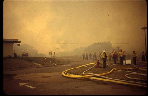 Firefighters provide structural protection to commercial buildings during the Bircher fire, Mesa Verde National Park, July 2000