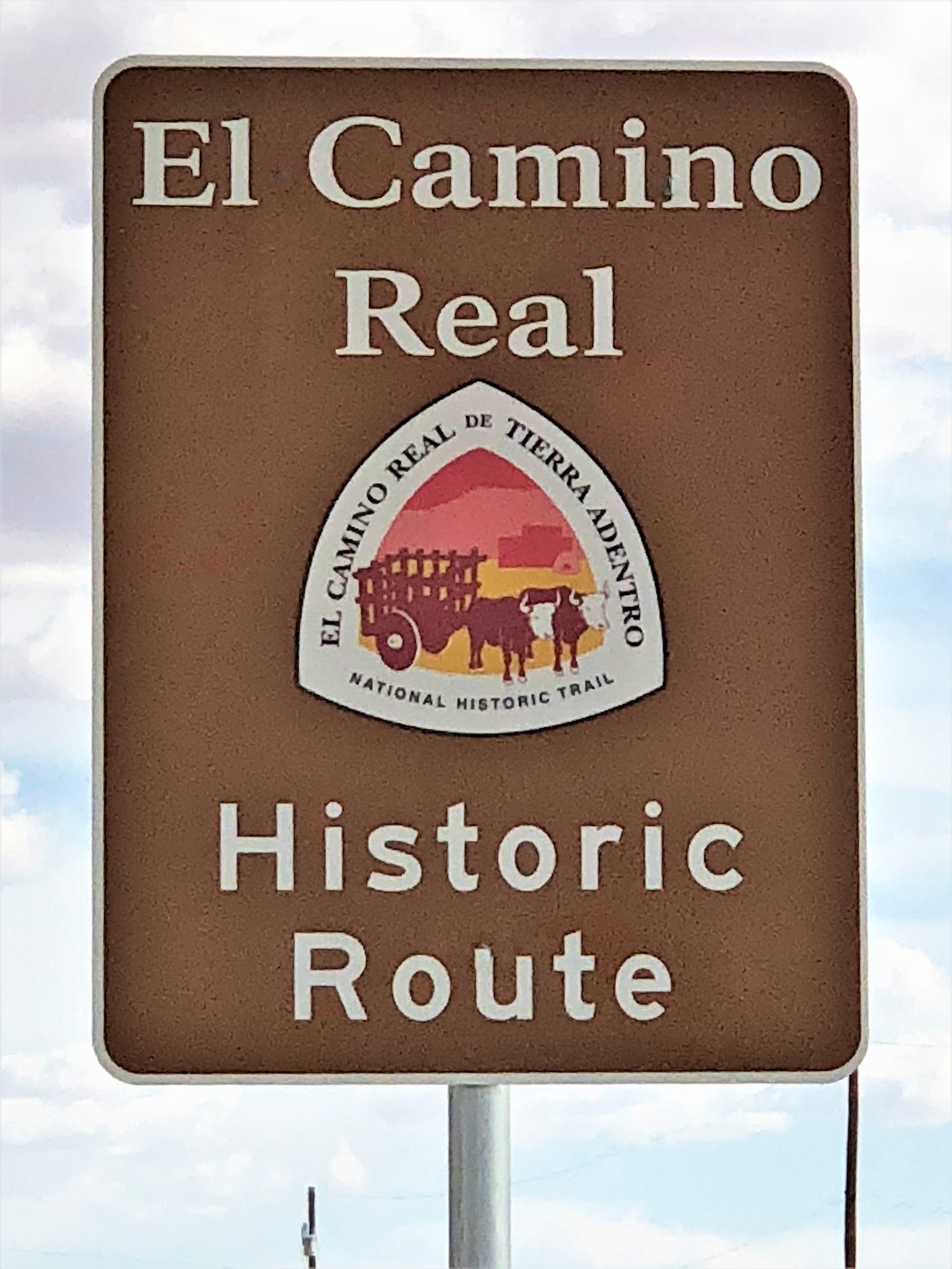 A sign with the text "el camino rail historic route" on it.