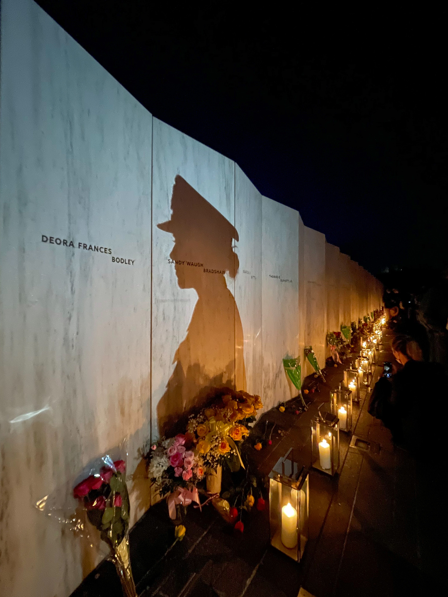 A sailor's shadow on the Wall of Names.