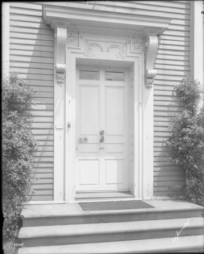 Black and white photograph of ornate front door.