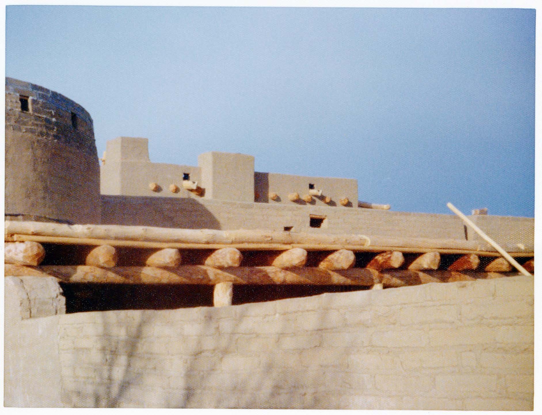 The walls of the fort and back corral shade structure are visible. Cactus has not yet been planted along the top of the corral wall. 