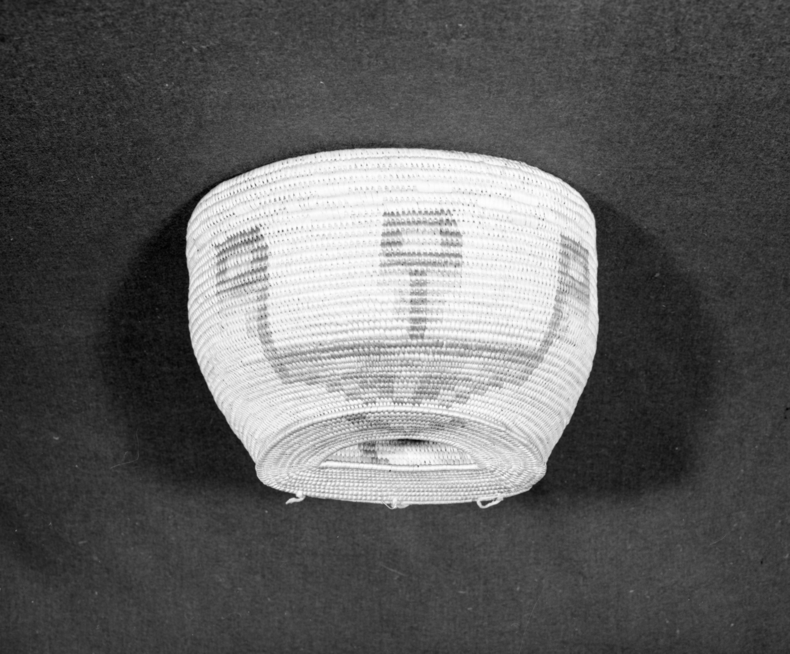 Marie Rozier Collection, Catalog No. 89. Object: Jicarilla Apache fishing creel. Dimensions: 15 x 10". Materials: willow, dyes, buckskin. Technology: non-interlockingstitching with areas of wrapped coil. Collection History: From Susie Smith, made for Charles Smith but never used because it was too heavy. c. 1900. Photographed by Michael Dixon, December 1982. Catalogued by Craig Bates and Barbara Beroza. Yosemite Collections, National Park Service.