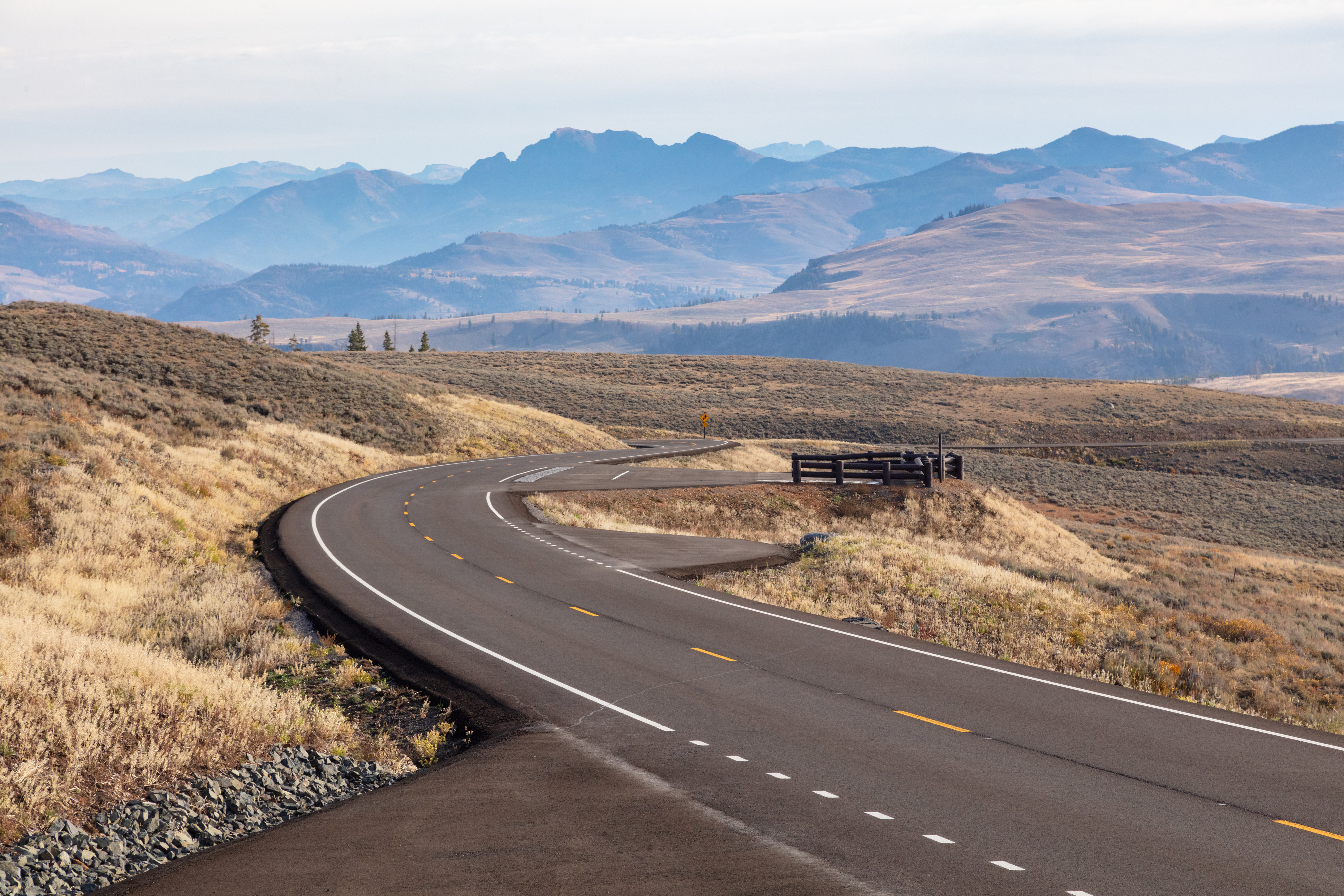 Two laned paved road with mountains in the background