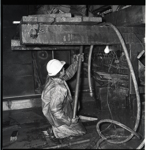 Worker works with drill rig during test hole drilling in Zion-Mt. Carmel tunnel.