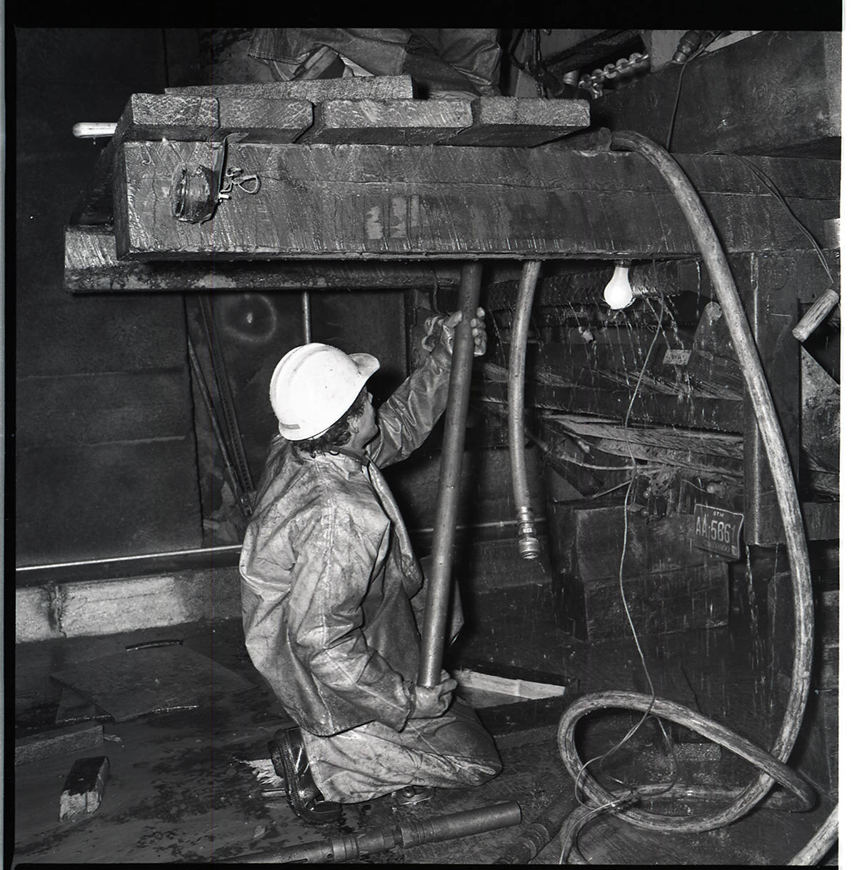 Worker works with drill rig during test hole drilling in Zion-Mt. Carmel tunnel.