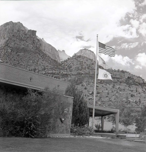 Mission 66 Visitor Center and Museum and bicentennial flags. [One of two images on single film strip for ZION 9061]