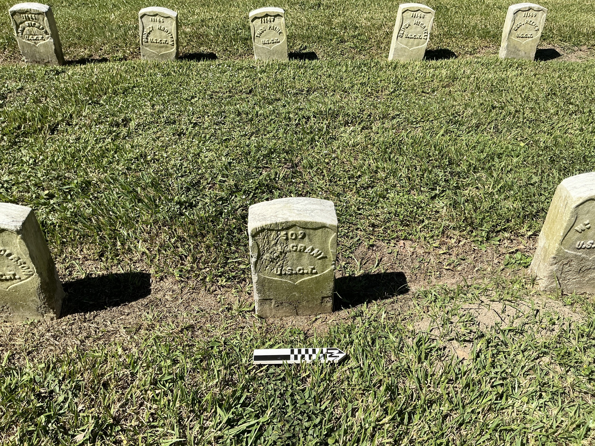 Extra image of historic upright marble headstone with recessed shield face.