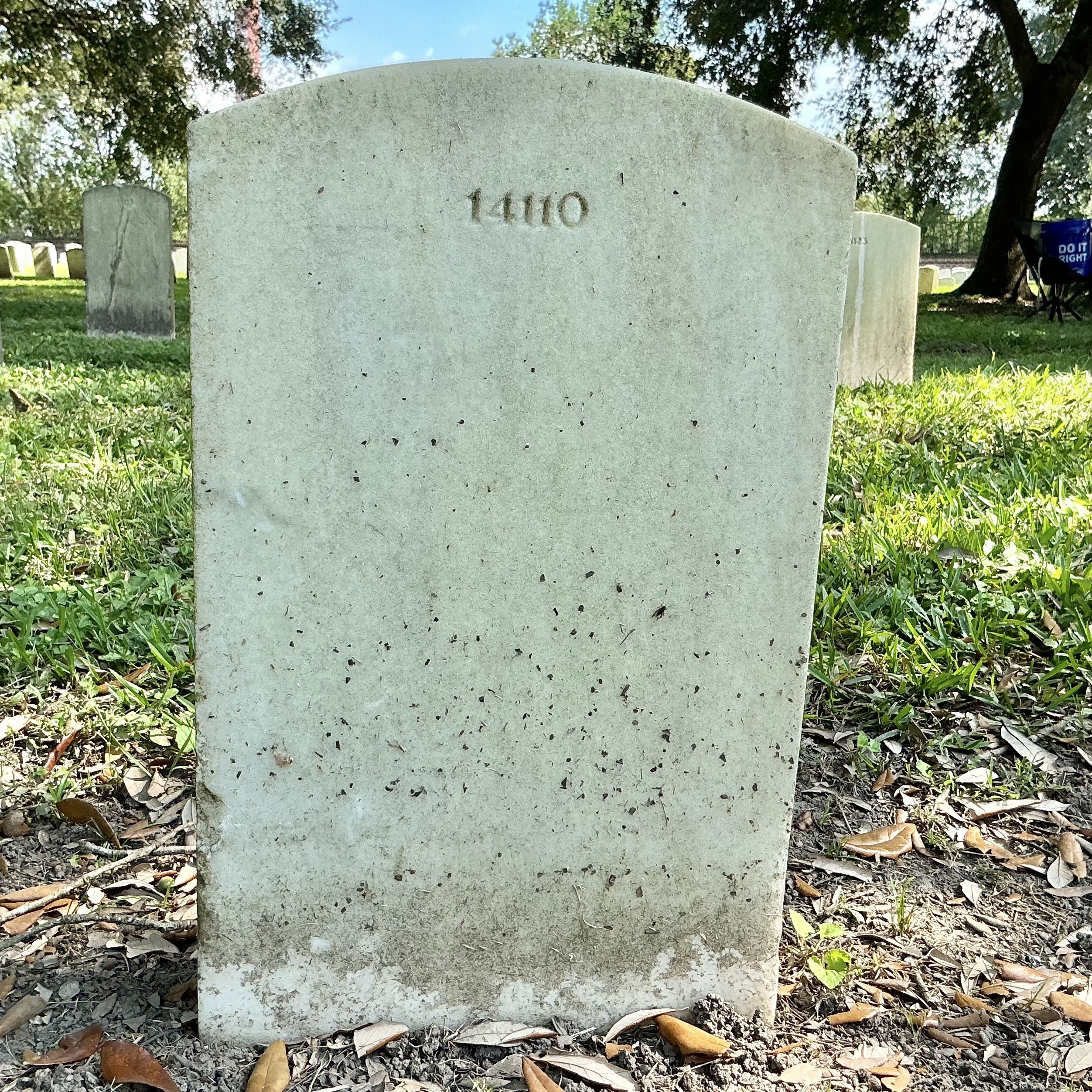 Back of upright marble headstone with flat face.