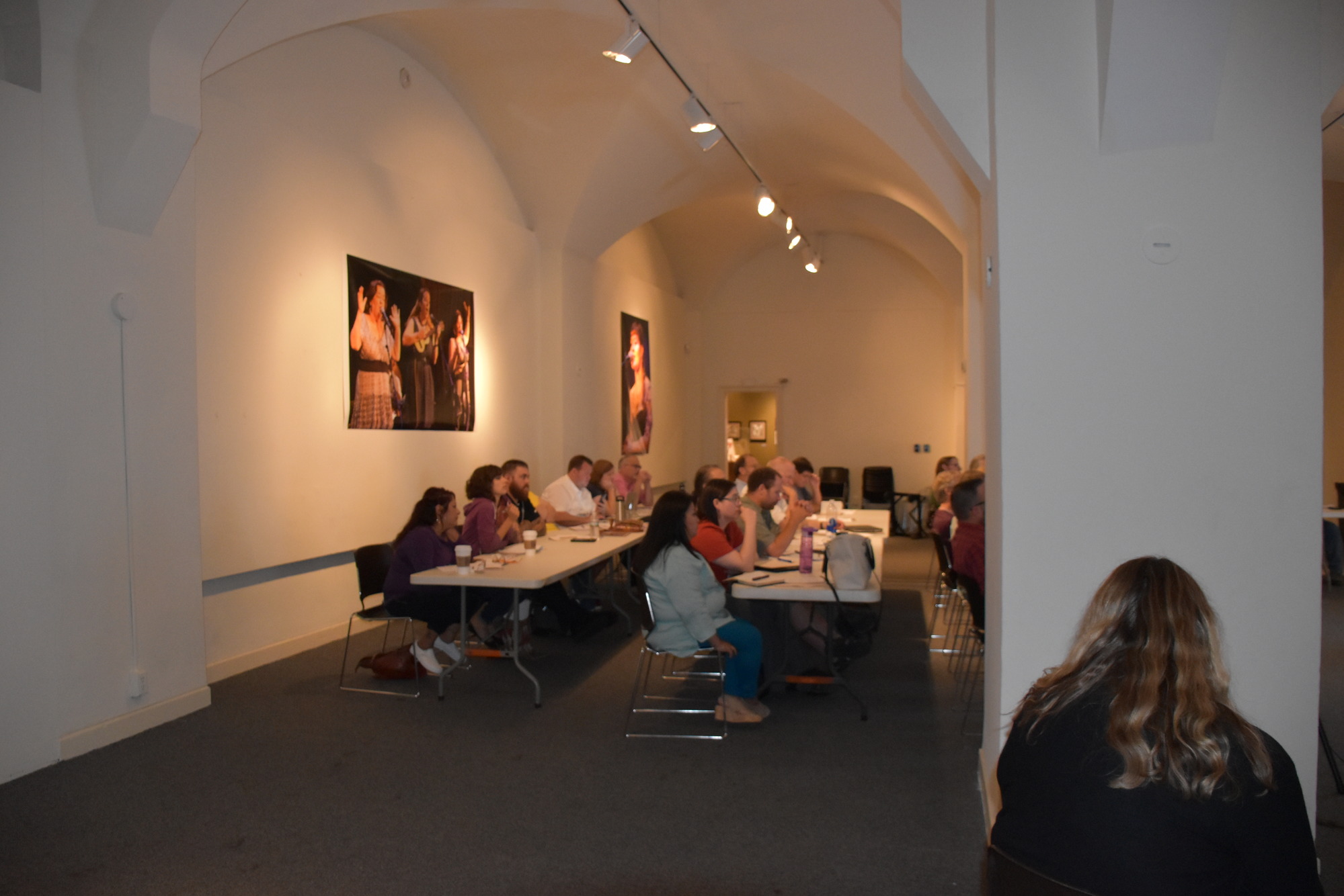 people sitting at tables in a classroom.
