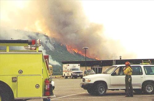 Firefighters provide structural protection to commercial buildings during the Bircher fire, Mesa Verde National Park, July 2000