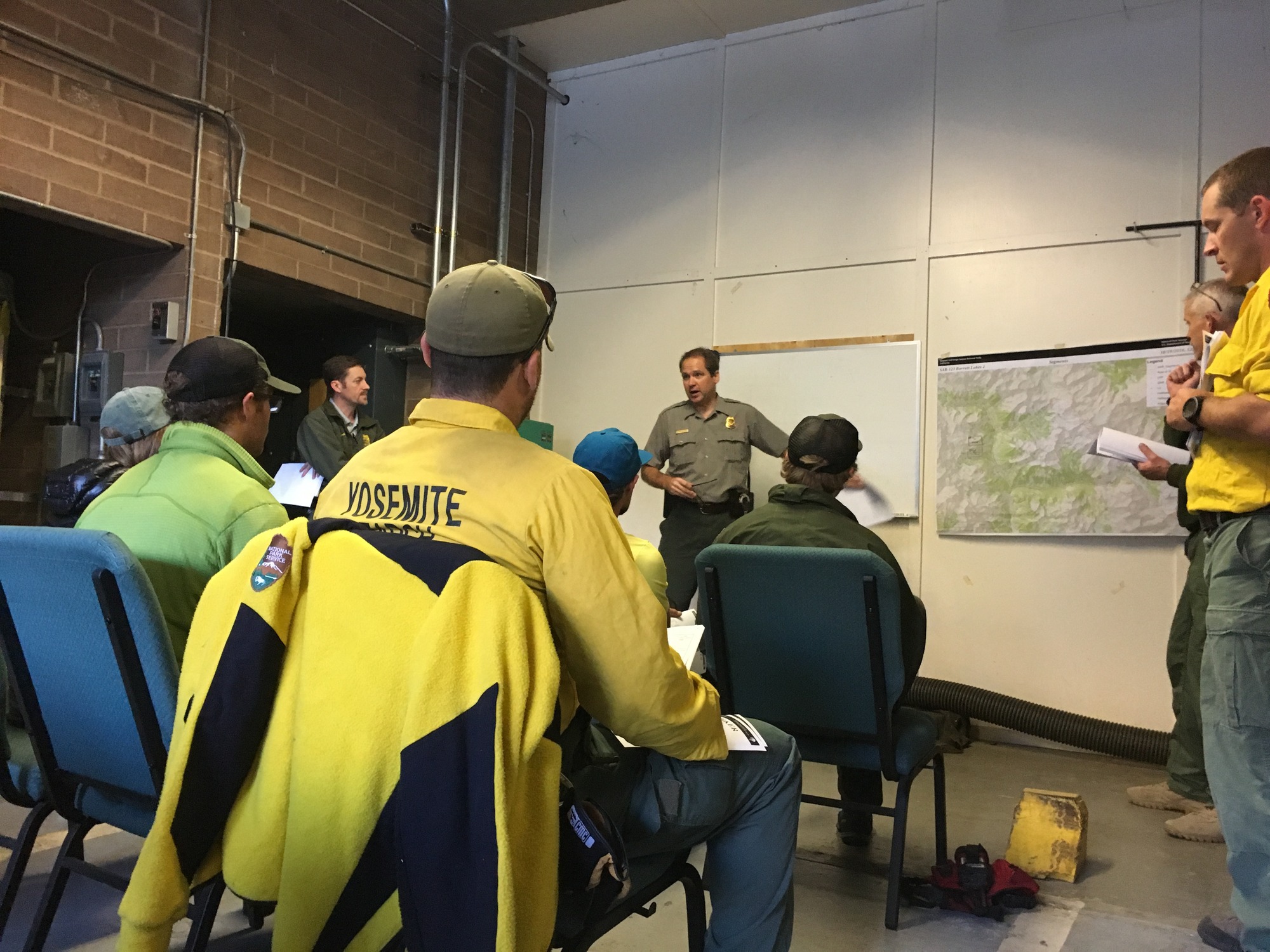 Field team leaders attend an operational briefing. 