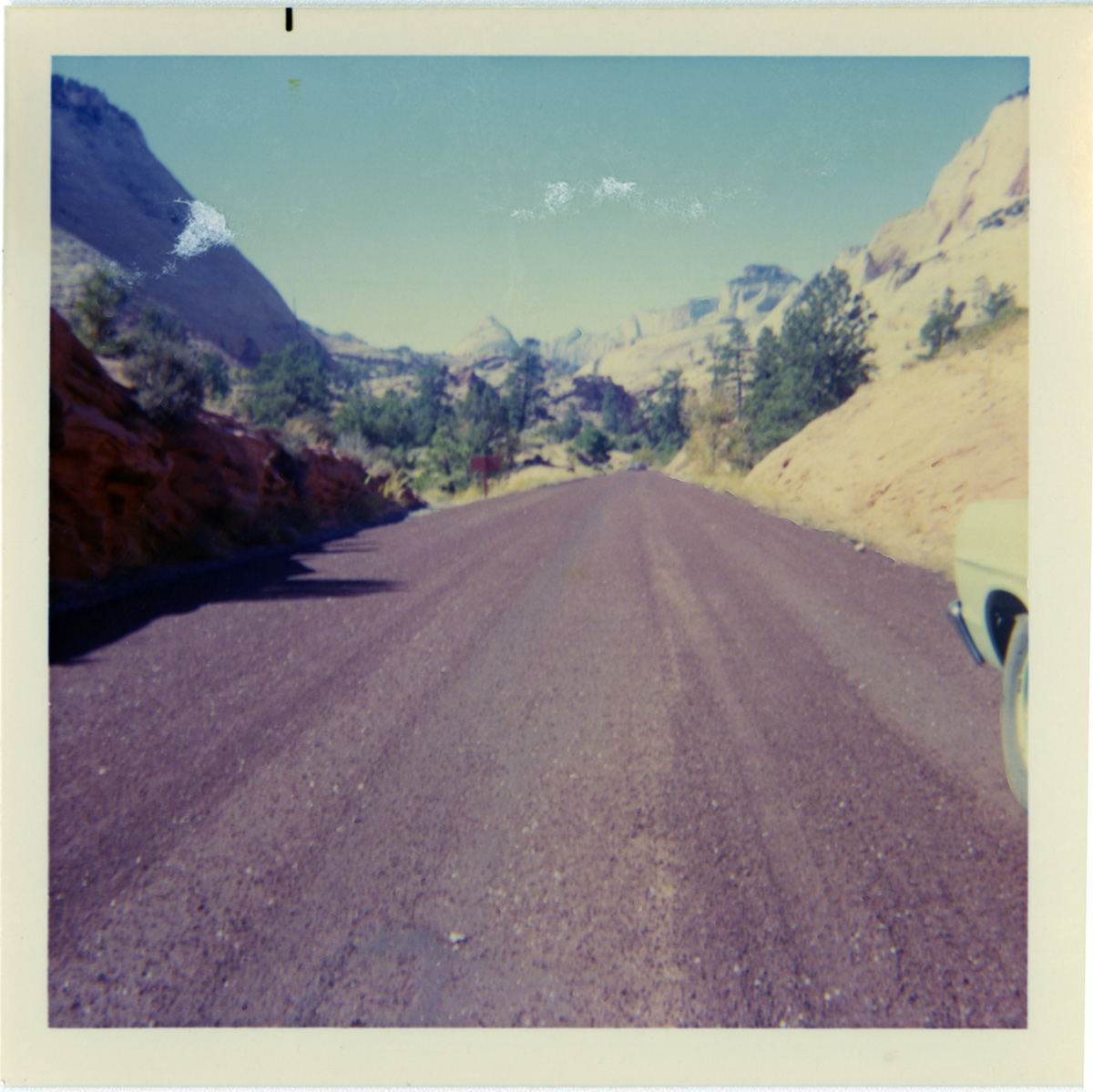 Road with surrounding landscape during chipsealing of Zion roads.