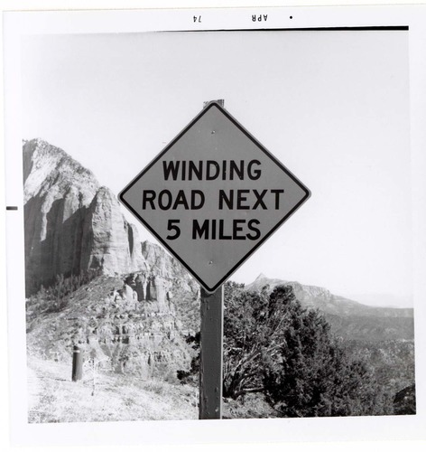 Road sign reading 'Winding Road Next 5 Miles' in Kolob Canyon.