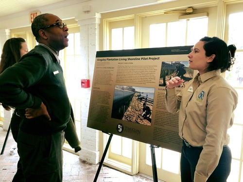 ranger and intern talk next to poster presentation 