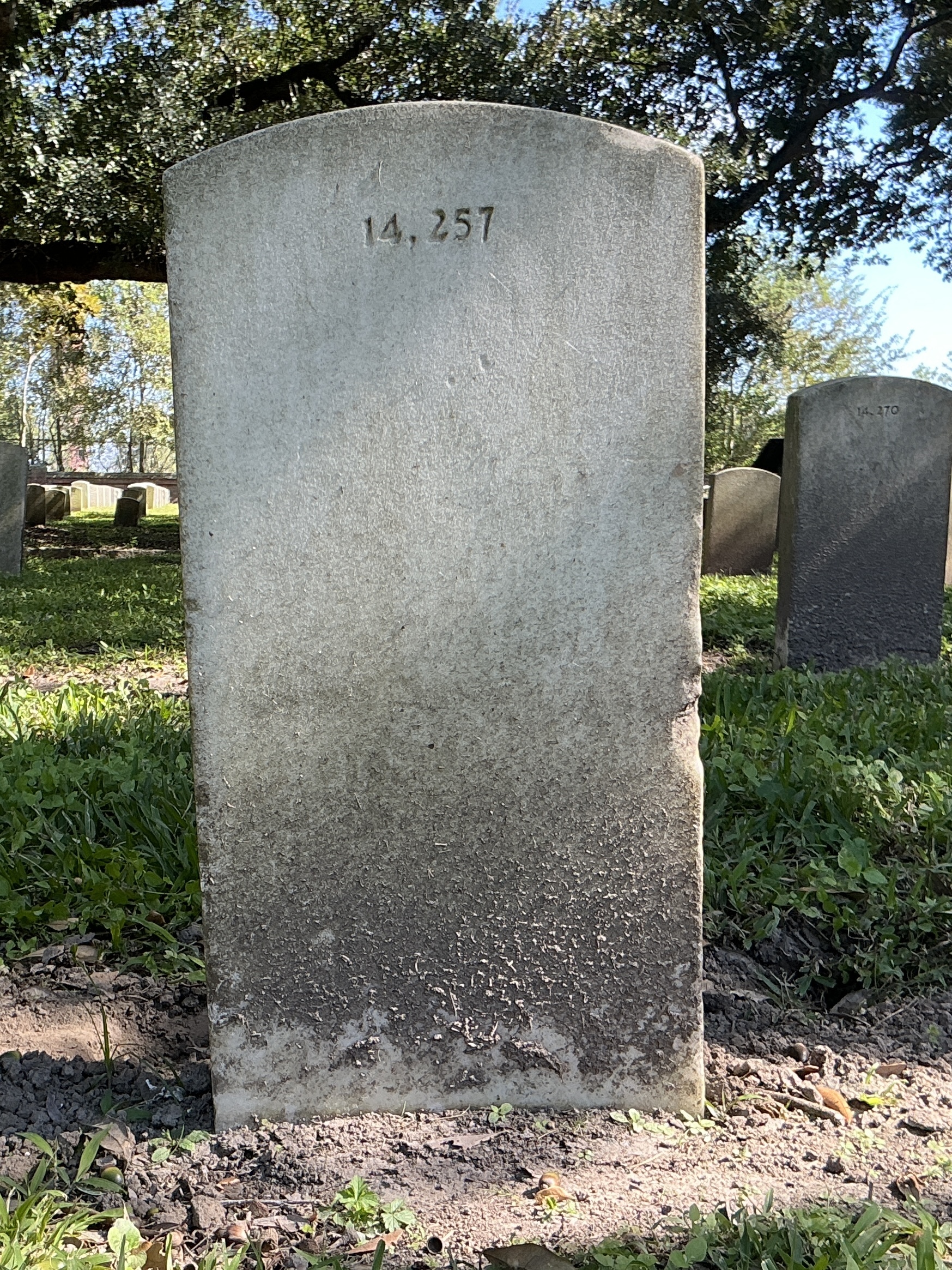 Back of upright marble headstone with flat face.