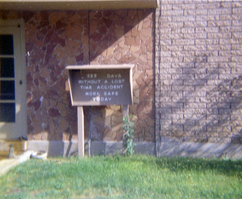 Sign reading '# of days without a lost time accident work safe today' outside of headquarters.