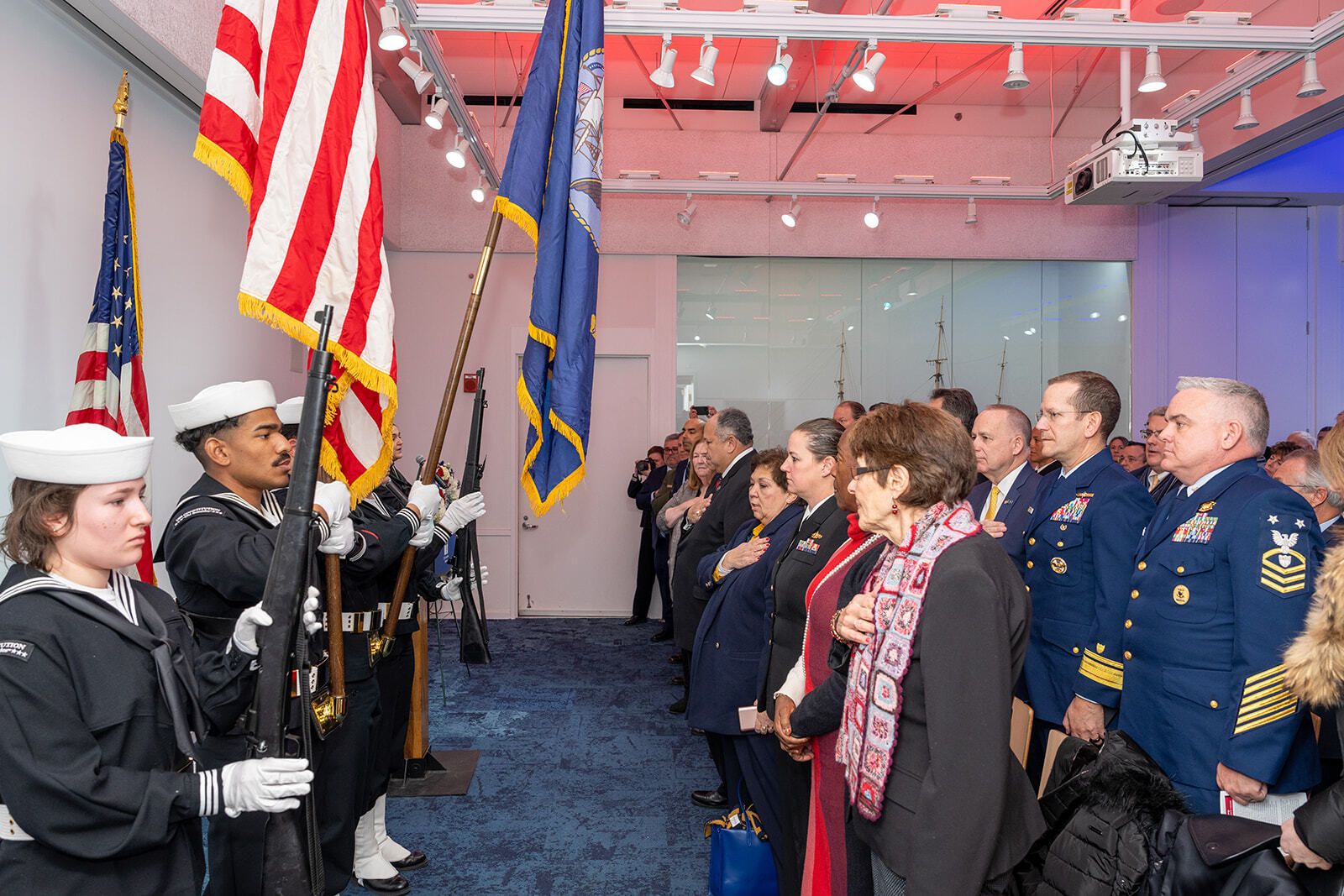 Color guard presenting colors in front of an audience.