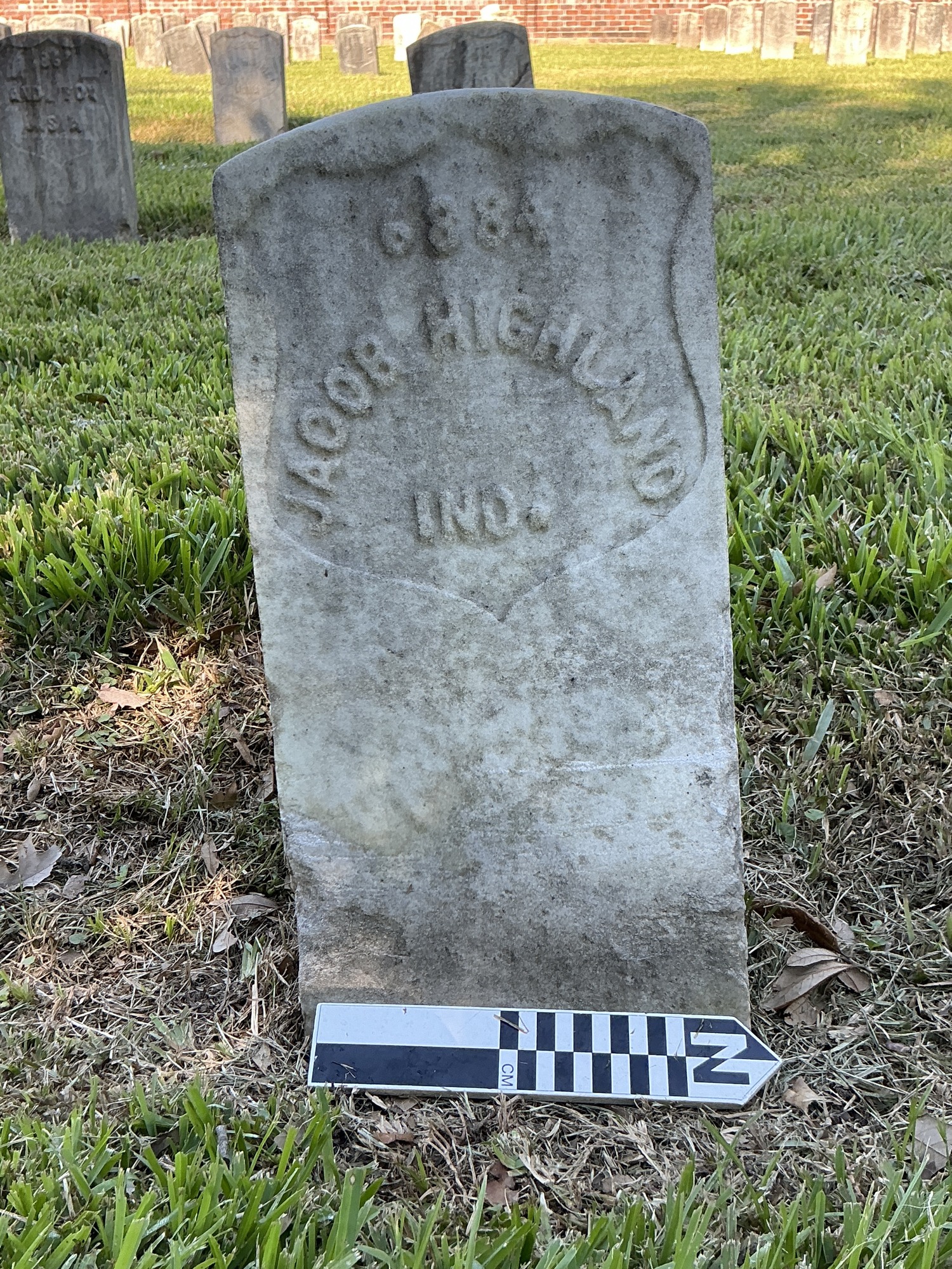 Extra image of historic upright marble headstone with recessed shield face.