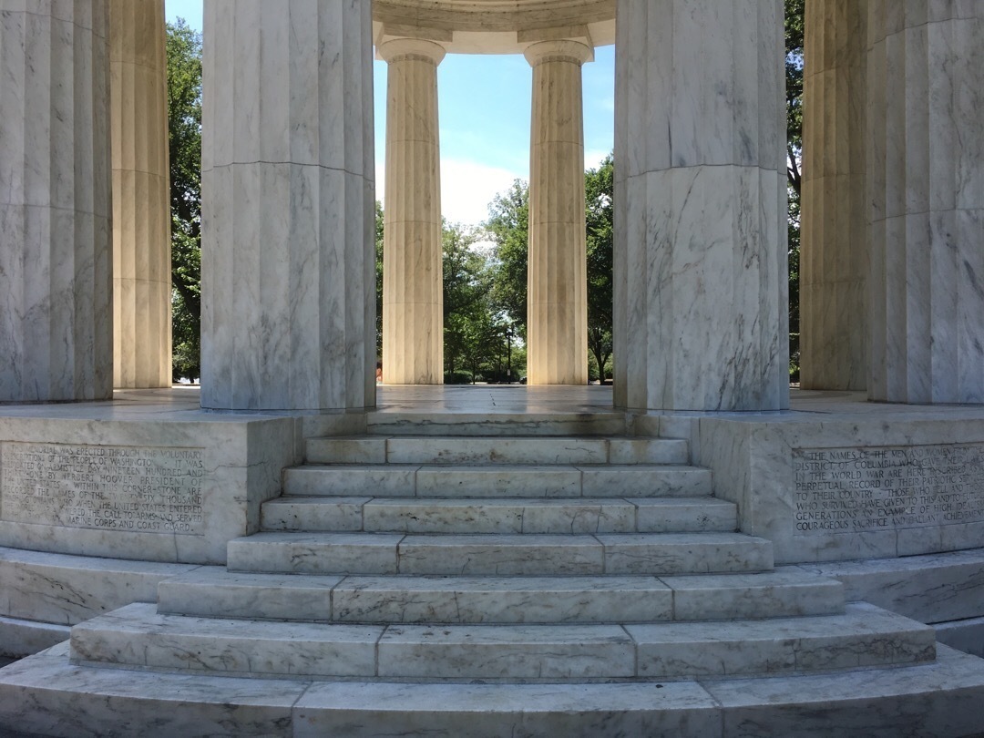 Marble steps and columns of a small, open circular structure. 