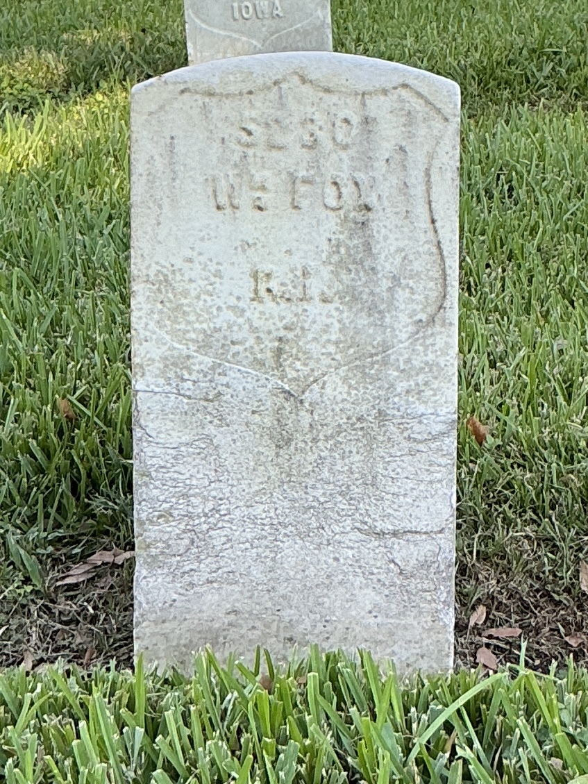 Front of historic upright marble headstone with recessed shield face.