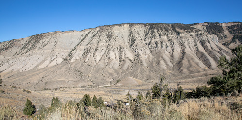 Looking at a flat topped mountain with horizontal layers of rock exposed
