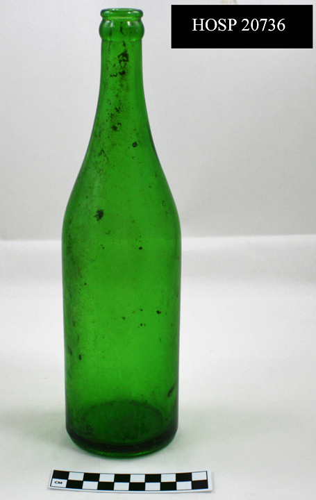 Emerald green glass bottle with visible side seams. Base of bottle manufactured with a cup bottom mold seam. Once had an applied color label attached. Bottom embossed with "9", "5", and "52". these numbers surround a logo comprised of a capital "I" encased within an overlapping diamond and oval. This logo indicates that this bottle was manufactured by the Owens-Illinois Glass Co., which operated between 1929-1960. 
