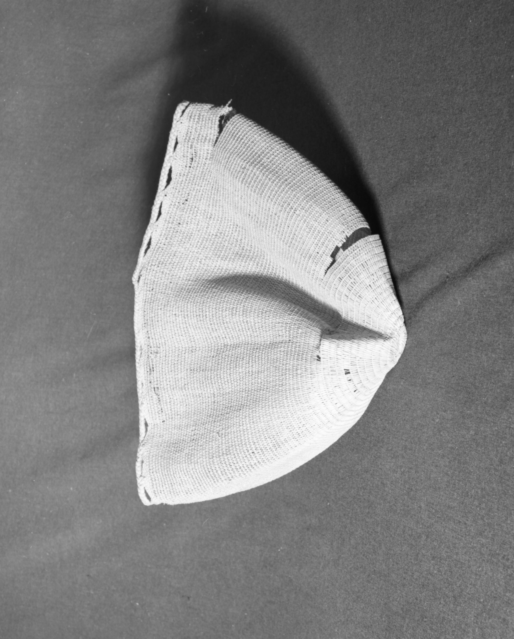 Marie Rozier Collection, Catalog No. 5-13-FM. Object: Aleut bag. Dimensions: 14" x 14". Materials: seagrass, Technology: plain and diagonally twined, down to right slant of turns. Collection History: Gift of Flora Hill McCullough. Photographed by Michael Dixon, December 1982. Catalogued by Craig Bates and Barbara Beroza. Yosemite Collections, National Park Service.