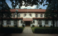 Color photo of entrance to Hale Bathhouse. Central sidewalk. Lamppost on right.