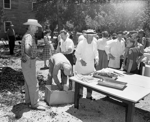 Bane Mattson, chief chef, prepares meat for barbecue following the dedication program at Mission 66 Visitor Center and Museum. Crowd of men and women gathered nearby ranger dormitory. Over 600 people attended ceremony.