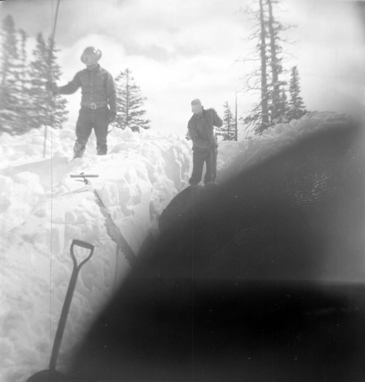BW Photos showing rangers digging out the visitor center from snowdrift.