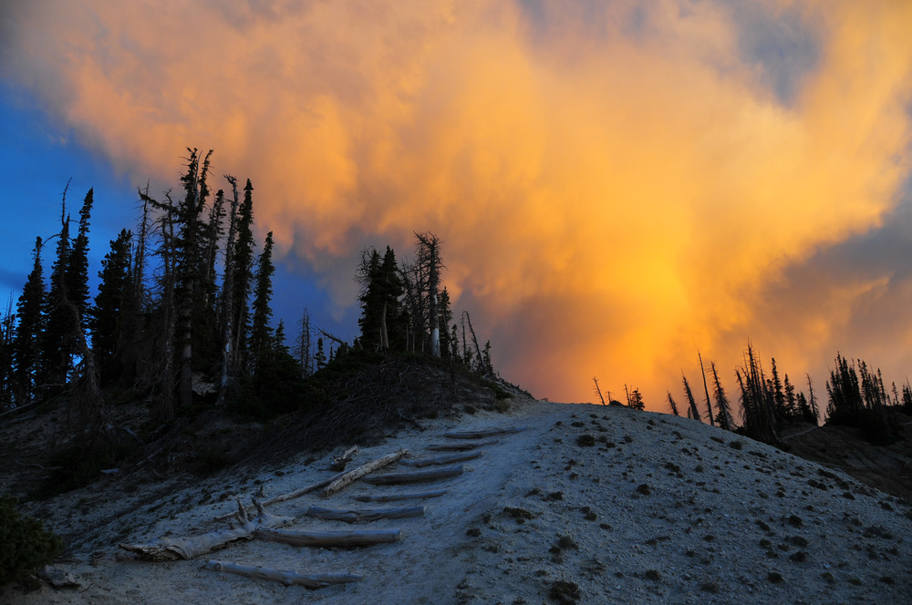 The light fades away and turns the clouds yellow on Spectra Point Trail