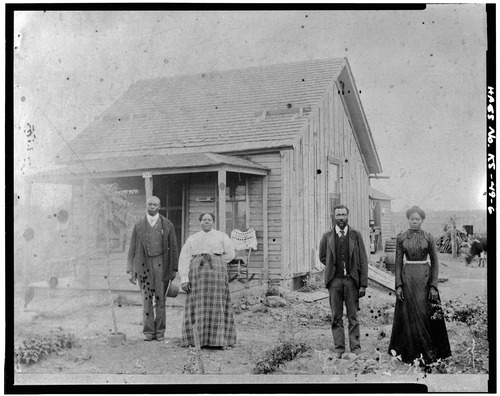 people standing in front of a house